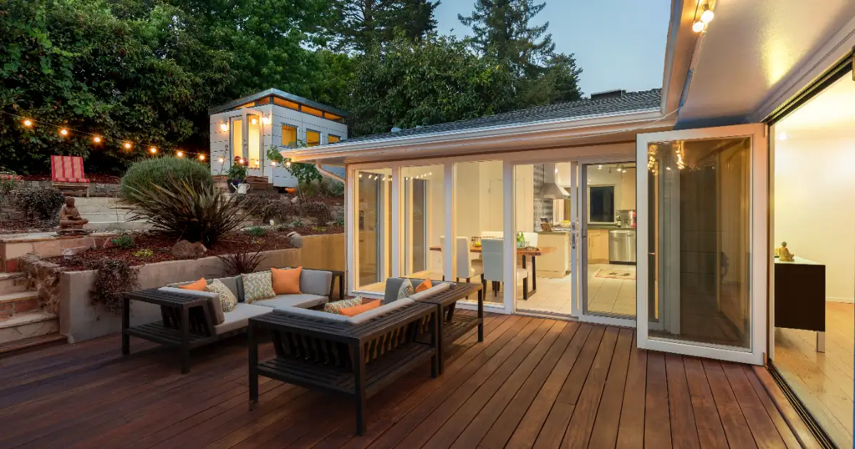 an outdoor wooden deck attached to a modern home