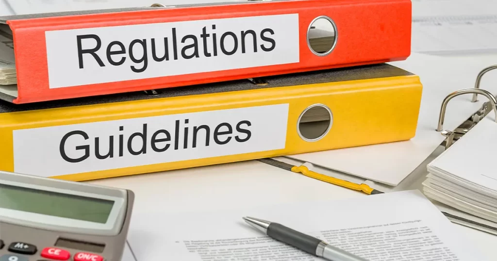 two binders labeled _Regulations_ and _Guidelines,_ representing different levels of authoritative rules and recommendations in a professional or legal context