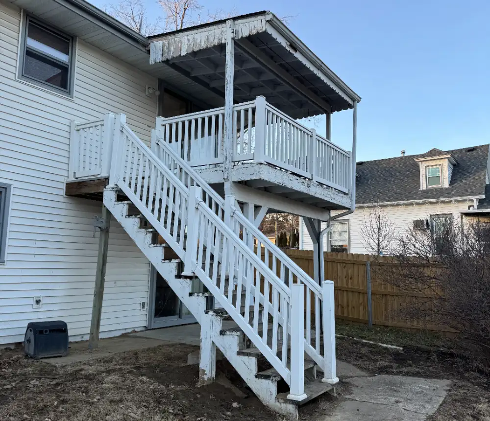 Elevated Cedar Deck Rebuild an old two-story exterior deck and staircase attached to a house