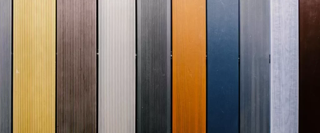 Close-up of high-quality composite deck materials showing wood grain texture and grey finish.