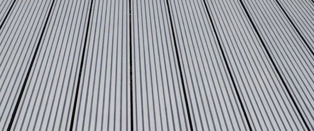 Close-up view of durable grey composite decking boards showing realistic wood grain.