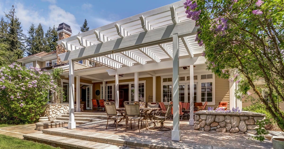 A cozy wooden backyard deck set up for spring deck projects with comfortable seating.