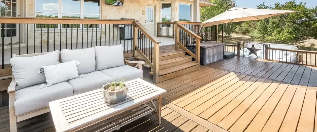 A beautiful multi-level custom wood deck overlooking a landscaped backyard.