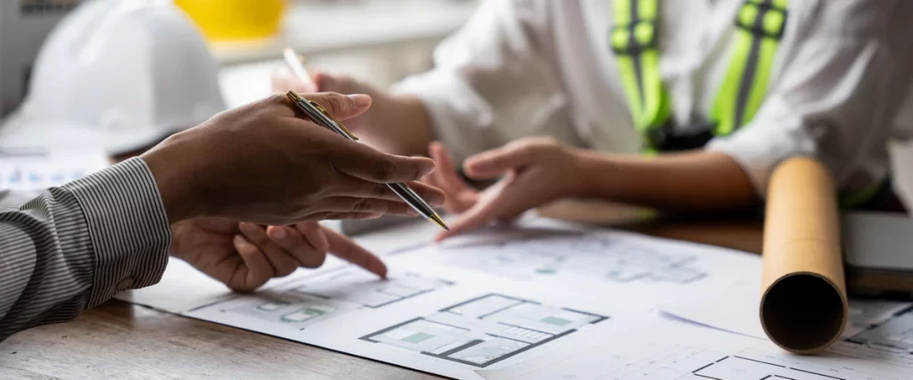 Legal documentation and residential building permits resting on a wooden surface for a deck project.