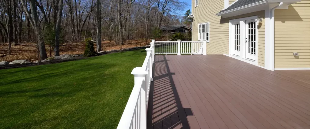 The shaded area underneath a high-profile deck highlighting the concrete foundation footings and wooden support structure.